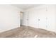 Bright, carpeted bedroom featuring neutral walls and two paneled doors at 19060 E 54Th Pl, Denver, CO 80249