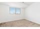 Bedroom with neutral colored carpet, white walls, and a large window at 19060 E 54Th Pl, Denver, CO 80249