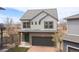 Charming two-story home featuring a two-car garage, a well-manicured yard, and stylish architectural details at 19060 E 54Th Pl, Denver, CO 80249