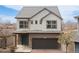 Charming two-story home featuring a two-car garage, a well-manicured yard, and stylish architectural details at 19060 E 54Th Pl, Denver, CO 80249