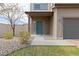 Inviting front entrance with a stylish door, well-maintained landscaping, and a charming walkway at 19060 E 54Th Pl, Denver, CO 80249