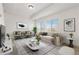 Bright living room with comfortable seating, stylish decor, and large windows offering ample natural light at 19060 E 54Th Pl, Denver, CO 80249