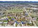Aerial view showing a well-established neighborhood with many trees, green spaces, and the property's setting at 7737 S Dover St, Littleton, CO 80128