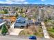Aerial view of home with mature trees, and a blue car parked in front at 7737 S Dover St, Littleton, CO 80128