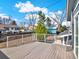 Spacious wood back deck with white railings offers great views of the backyard at 7737 S Dover St, Littleton, CO 80128