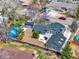 An aerial view of the backyard with a shed, patio, play structure, privacy fence and mature landscaping at 7737 S Dover St, Littleton, CO 80128