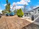 Home with a large backyard with mature landscaping, patio, and a detached garage at 7737 S Dover St, Littleton, CO 80128