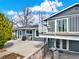 Backyard with a concrete patio, outdoor seating, and mature landscaping at 7737 S Dover St, Littleton, CO 80128