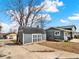 Backyard with a detached garage, tool shed, and patio at 7737 S Dover St, Littleton, CO 80128
