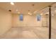 Open basement space with concrete floor, ready to be transformed with endless possibilities for design and function at 7737 S Dover St, Littleton, CO 80128