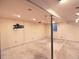 Bare basement room featuring a concrete floor, painted walls, and open ceiling, ready for renovation at 7737 S Dover St, Littleton, CO 80128