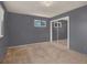 Gray bedroom showcasing carpet, windows, and mirrored closet at 7737 S Dover St, Littleton, CO 80128