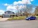 Two-story home with a two-car garage, brick accents, and a well-manicured lawn at 7737 S Dover St, Littleton, CO 80128