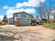 This two-story home has a spacious two-car garage and an additional separate garage at 7737 S Dover St, Littleton, CO 80128