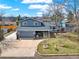 Charming blue home with mature trees and well-maintained front yard at 7737 S Dover St, Littleton, CO 80128