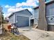Attached garage with a large driveway perfect for workshop or hobbies at 7737 S Dover St, Littleton, CO 80128