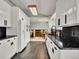 Open concept kitchen with granite countertops, and white cabinetry at 7737 S Dover St, Littleton, CO 80128