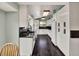Well-lit kitchen with granite countertops, white cabinets, and stainless steel appliances at 7737 S Dover St, Littleton, CO 80128