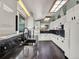 Modern kitchen boasts granite counters, white cabinets, and updated appliances at 7737 S Dover St, Littleton, CO 80128