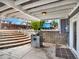 Relax on this covered patio complete with stone steps and concrete base at 7737 S Dover St, Littleton, CO 80128
