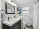 Bright bathroom featuring a double vanity, a toilet, and a shower with a curtain at 1060 S Harrison St, Denver, CO 80209