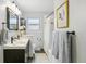 Bright bathroom featuring a double vanity, a toilet, and a shower with a curtain at 1060 S Harrison St, Denver, CO 80209