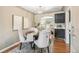 Dining area with hardwood floors, neutral decor, and seating for four at 1060 S Harrison St, Denver, CO 80209