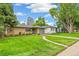 Well-maintained home features a classic design, complemented by a lush green lawn and mature landscaping at 1060 S Harrison St, Denver, CO 80209