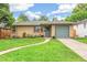 Charming brick home with a well-manicured lawn and inviting curb appeal at 1060 S Harrison St, Denver, CO 80209