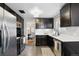 Updated kitchen features stainless steel appliances and dark cabinets at 1060 S Harrison St, Denver, CO 80209