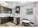 Modern kitchen featuring dark cabinets, white countertops, and stainless steel appliances at 1060 S Harrison St, Denver, CO 80209