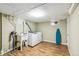 Functional laundry room with sink, modern washer and dryer, and wood-look vinyl flooring at 1060 S Harrison St, Denver, CO 80209
