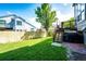 Fenced backyard features a green lawn, wooden fence, and stairs to the deck at 1932 Sandhurst Dr, Castle Rock, CO 80104