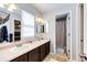 Bathroom with dual sinks and dark wood vanity at 1932 Sandhurst Dr, Castle Rock, CO 80104