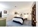 Cozy bedroom features unique decor, soft blue carpet, and rustic wooden storage at 1932 Sandhurst Dr, Castle Rock, CO 80104