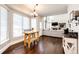 Cozy breakfast nook with natural light and views leading into the living room with fireplace at 1932 Sandhurst Dr, Castle Rock, CO 80104