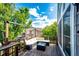 Relaxing outdoor deck features modern furniture and views of a tree-filled yard at 1932 Sandhurst Dr, Castle Rock, CO 80104