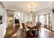 Elegant dining room featuring hardwood floors, a modern chandelier, and a bay window with decorative curtains at 1932 Sandhurst Dr, Castle Rock, CO 80104