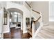 Open foyer featuring hardwood floors, staircase, and arched doorway to the living area at 1932 Sandhurst Dr, Castle Rock, CO 80104
