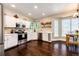 Bright kitchen with white cabinets, stainless steel appliances, and a view of the backyard at 1932 Sandhurst Dr, Castle Rock, CO 80104