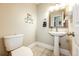 Classic powder room with pedestal sink, updated fixtures, and a decorative mirror at 1932 Sandhurst Dr, Castle Rock, CO 80104