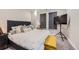 Bedroom featuring a soft gray headboard, stylish pillows, and a bright window view at 20 Wilcox St # 518, Castle Rock, CO 80104