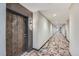 Hallway in condo with a decorative patterned carpet and elegant wooden door at 20 Wilcox St # 518, Castle Rock, CO 80104