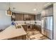 Bright kitchen boasts modern cabinets, stainless appliances, and a view of the unit's wood flooring at 20 Wilcox St # 518, Castle Rock, CO 80104