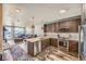 Open kitchen features modern appliances, granite countertops, and a view of the living room and balcony at 20 Wilcox St # 518, Castle Rock, CO 80104