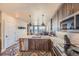 Contemporary kitchen featuring stainless appliances, granite countertops, and views of the home's living spaces at 20 Wilcox St # 518, Castle Rock, CO 80104