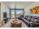 Cozy living room featuring a large sofa, modern decor, and an adjacent balcony overlooking the mountains at 20 Wilcox St # 518, Castle Rock, CO 80104