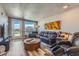 Modern living room with luxury recliner seating, hardwood floors, neutral paint, and city views from sliding glass doors at 20 Wilcox St # 518, Castle Rock, CO 80104