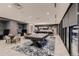 Open lounge area with pool table, seating and kitchen provides a versatile space for relaxing and entertaining at 20 Wilcox St # 518, Castle Rock, CO 80104