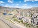 An aerial view of the community with a pond, walking paths, and mountain views at 15194 W Washburn Ave, Lakewood, CO 80228